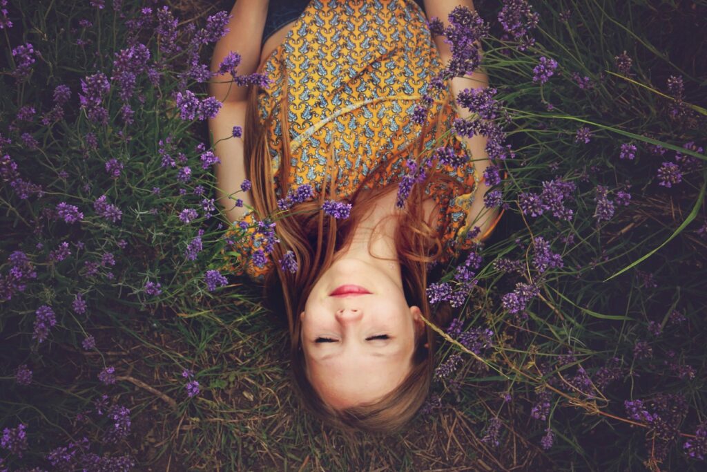 A woman lying among purple flowers
